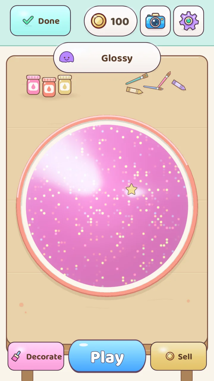 A glossy pink glitter slime with a star charm resting in its bowl, with Decorate, Play and Sell buttons